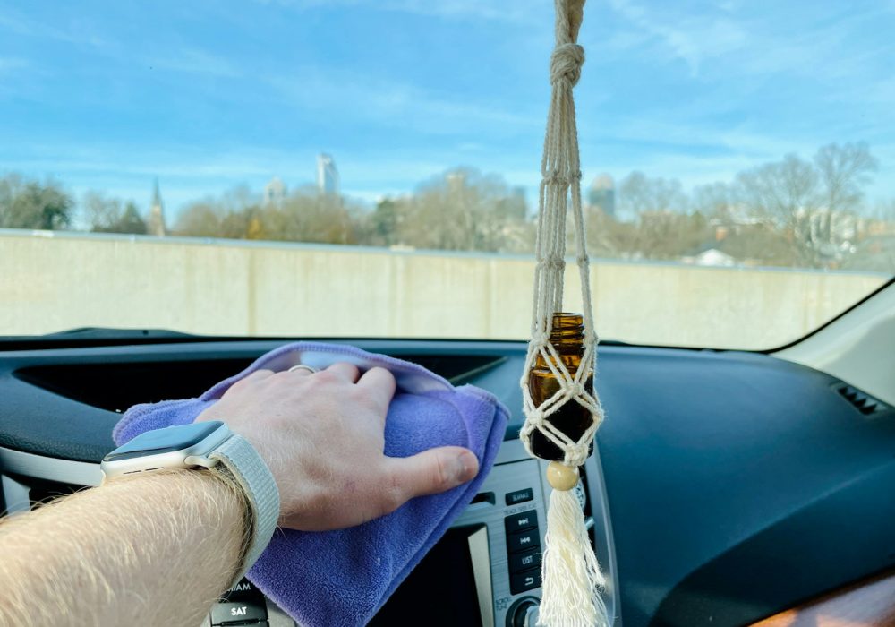 person in blue long sleeve shirt driving a car